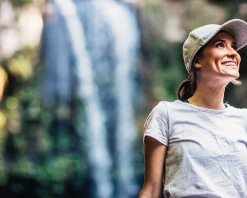 mount-tamborine-woman-smiling-at-witches-fall-on-bush-walk